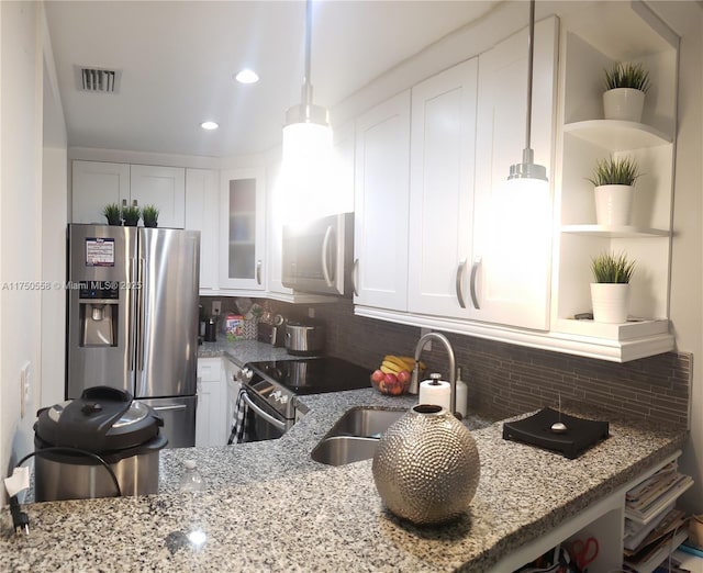 kitchen featuring stainless steel appliances, visible vents, light stone counters, and open shelves