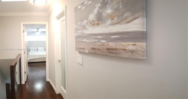 hallway with ornamental molding and wood finished floors