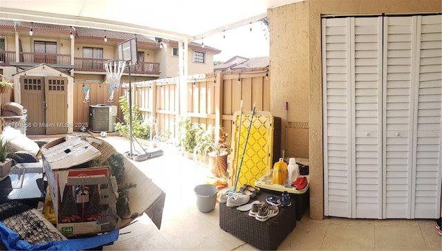 view of patio with cooling unit and fence