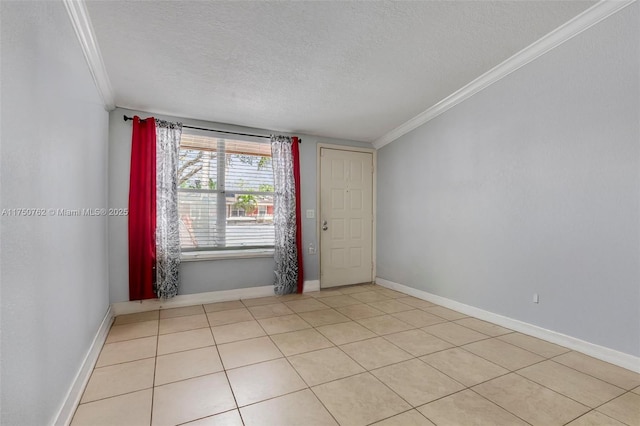 spare room featuring a textured ceiling, baseboards, and crown molding