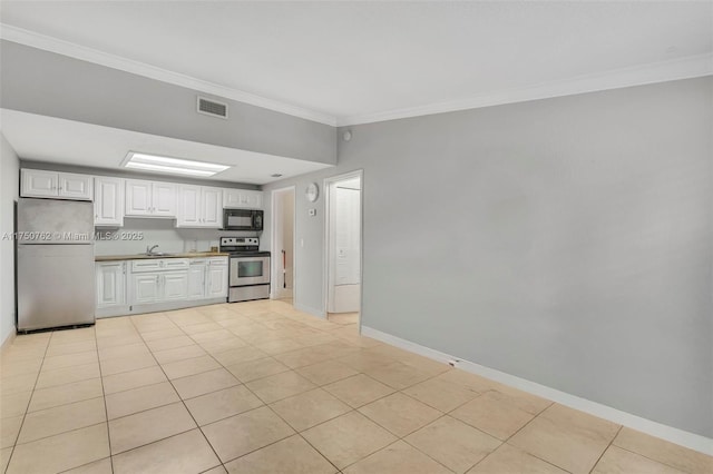 kitchen featuring light tile patterned floors, visible vents, white cabinetry, appliances with stainless steel finishes, and crown molding