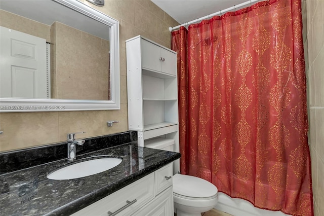 bathroom with tile walls, backsplash, toilet, shower / bath combo, and vanity