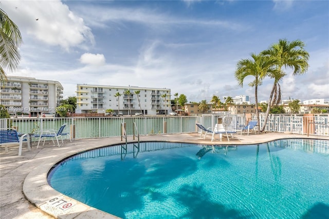 community pool featuring a patio area and fence