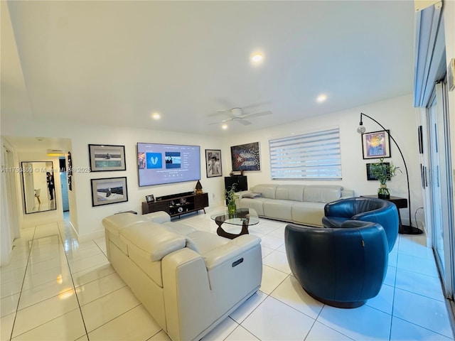 living area with light tile patterned floors, a ceiling fan, and recessed lighting