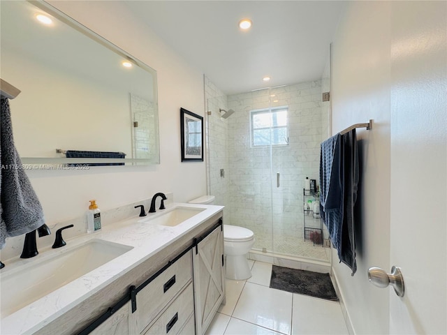 bathroom with double vanity, tile patterned flooring, a shower stall, and a sink