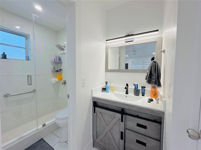 bathroom featuring a stall shower, vanity, toilet, and tile patterned floors