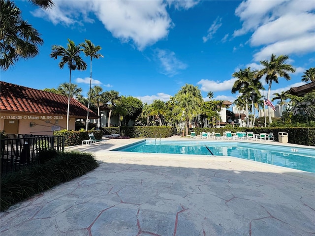 pool featuring a patio area and fence