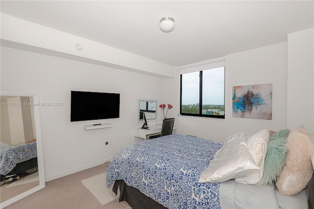 bedroom featuring light colored carpet and baseboards