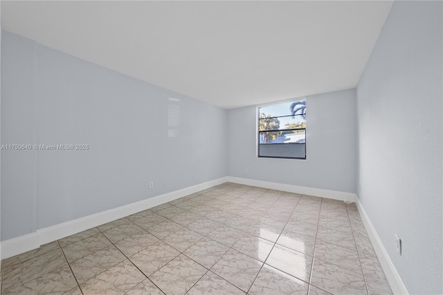 spare room featuring baseboards