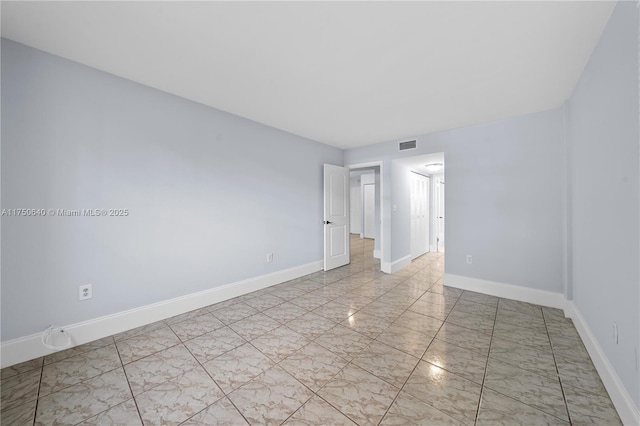 unfurnished bedroom with marble finish floor, visible vents, and baseboards