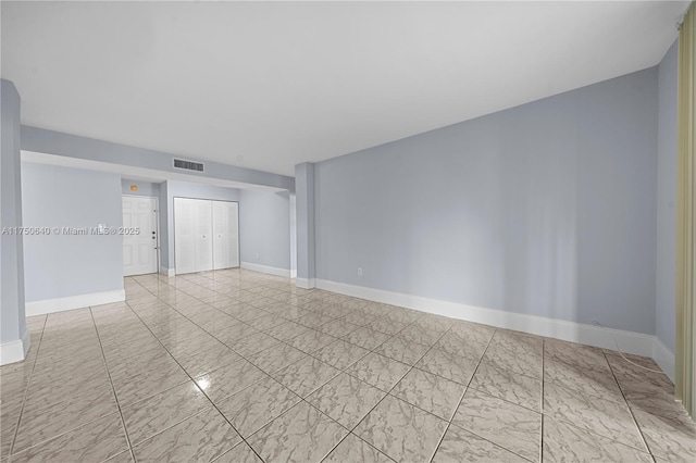 unfurnished room featuring marble finish floor, visible vents, and baseboards