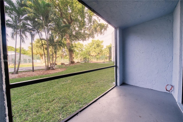 unfurnished sunroom with lofted ceiling