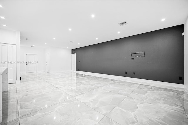 unfurnished room with recessed lighting, marble finish floor, and visible vents