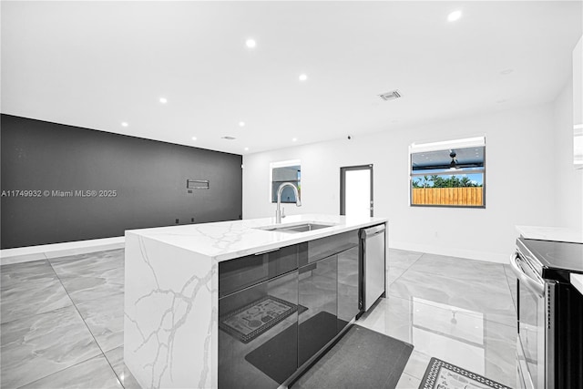 kitchen with marble finish floor, visible vents, appliances with stainless steel finishes, a sink, and an island with sink