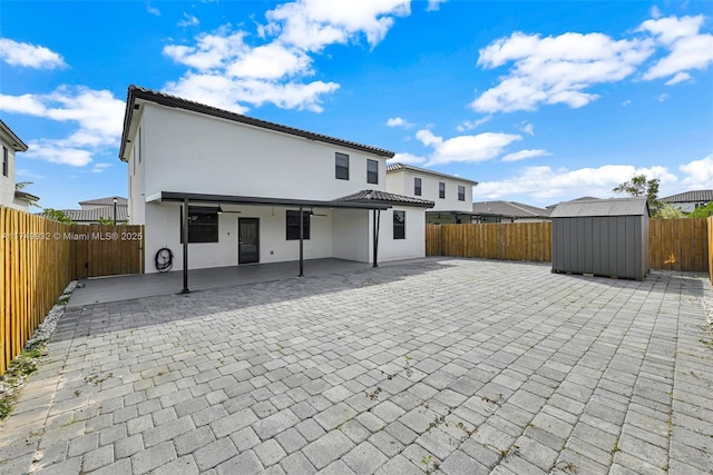 back of house with stucco siding, a fenced backyard, and a patio