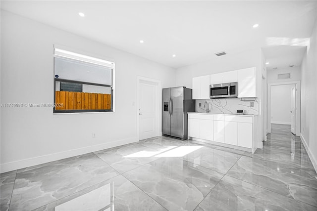 kitchen featuring visible vents, modern cabinets, appliances with stainless steel finishes, light countertops, and white cabinetry