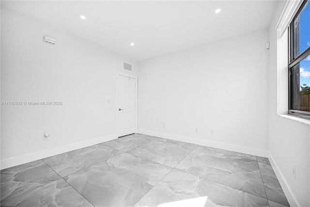 unfurnished room featuring recessed lighting, visible vents, and baseboards