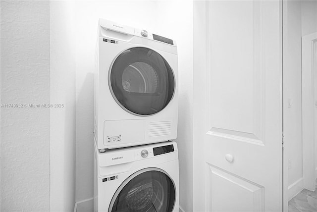 washroom with laundry area and stacked washing maching and dryer