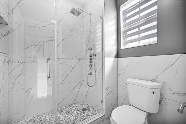 full bath featuring toilet and a marble finish shower