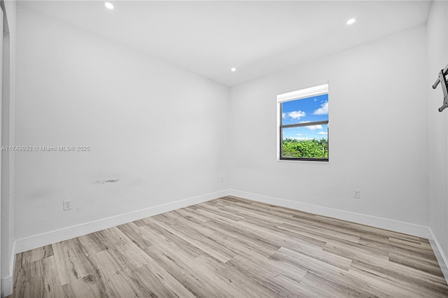 unfurnished room with light wood-style floors, recessed lighting, and baseboards