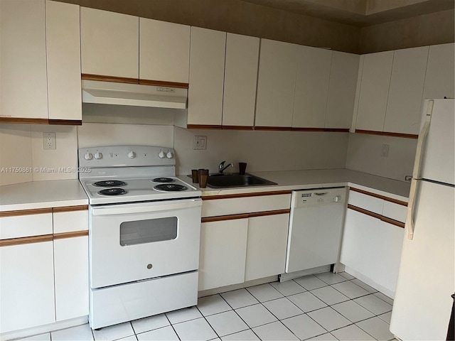 kitchen with light countertops, white appliances, white cabinets, and under cabinet range hood