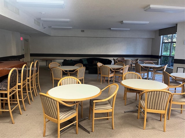 dining space featuring visible vents and a textured ceiling