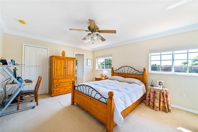 bedroom featuring baseboards, ornamental molding, a ceiling fan, and light colored carpet