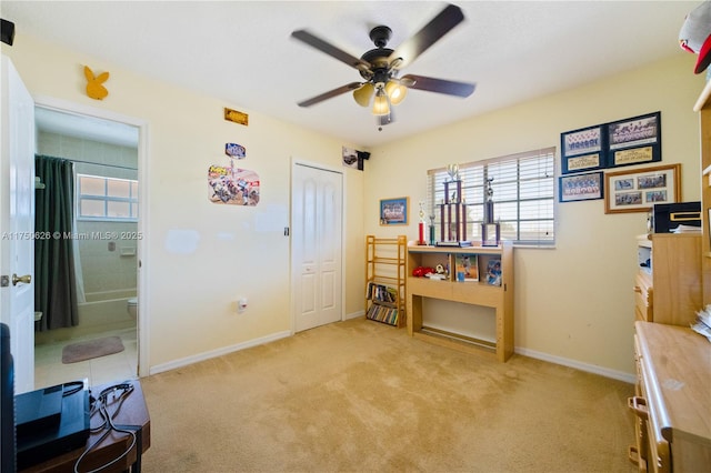 misc room with ceiling fan, plenty of natural light, baseboards, and light colored carpet