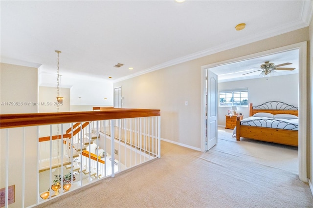 corridor featuring light colored carpet, visible vents, baseboards, an upstairs landing, and ornamental molding