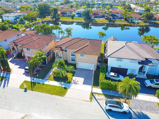 drone / aerial view with a residential view and a water view