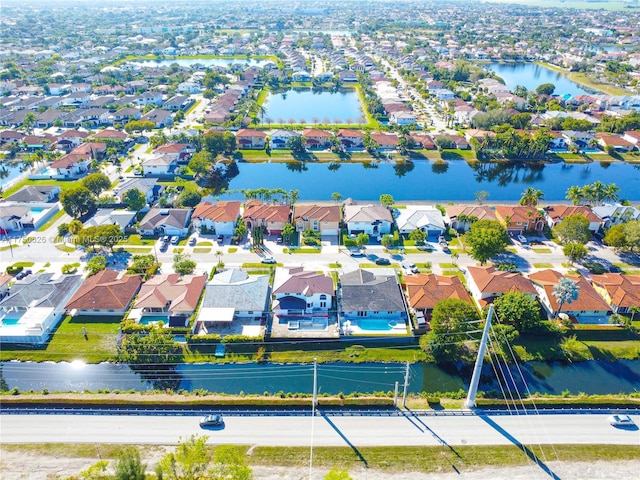 drone / aerial view featuring a water view and a residential view