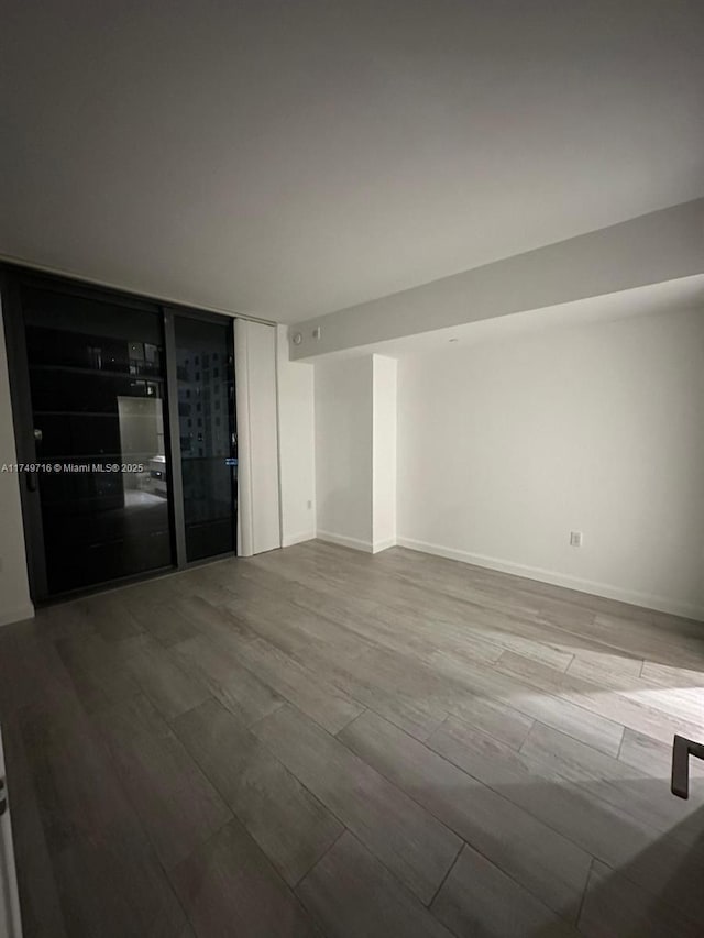 unfurnished room with light wood finished floors and baseboards