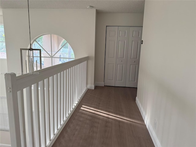 3962 Pinewood Ln, Weston, FL 33331 - hallway featuring baseboards, wood finished floors, and a textured ceiling