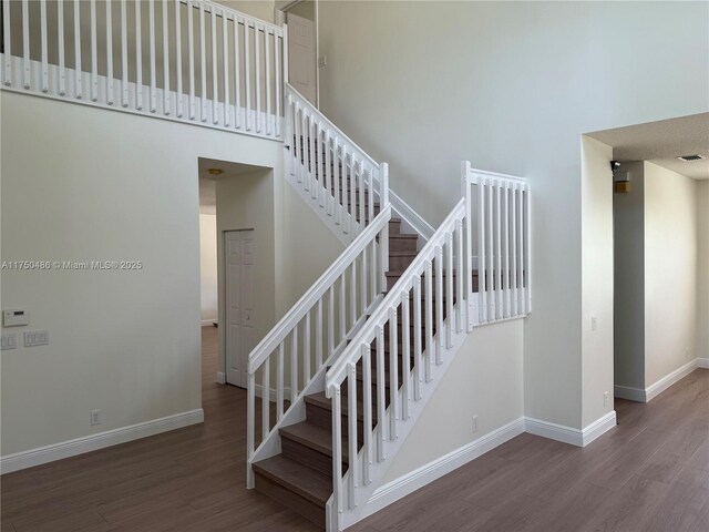 3962 Pinewood Ln, Weston, FL 33331 - stairs featuring wood finished floors, baseboards, and a high ceiling