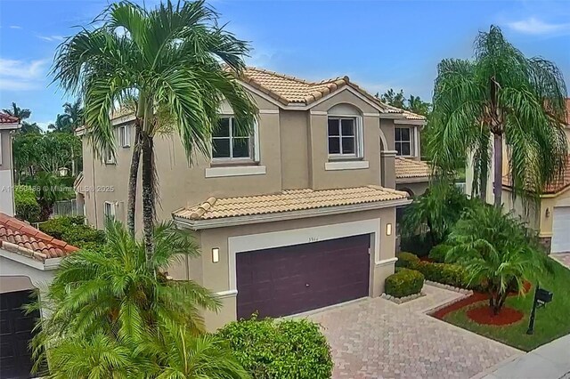 3962 Pinewood Ln, Weston, FL 33331 - mediterranean / spanish-style house with a tile roof, stucco siding, and driveway