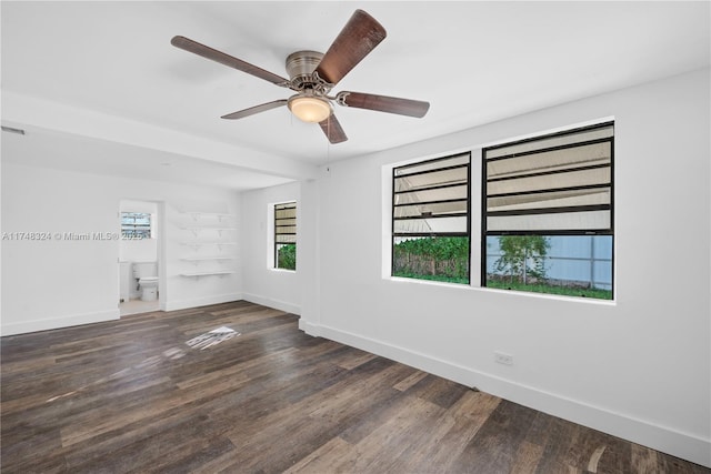 spare room with dark wood-style floors, baseboards, and a ceiling fan