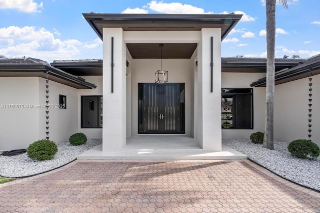 view of exterior entry with stucco siding