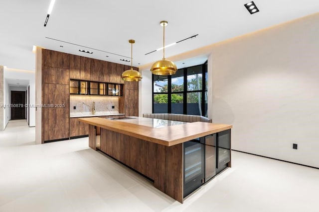 kitchen featuring glass insert cabinets, pendant lighting, and modern cabinets