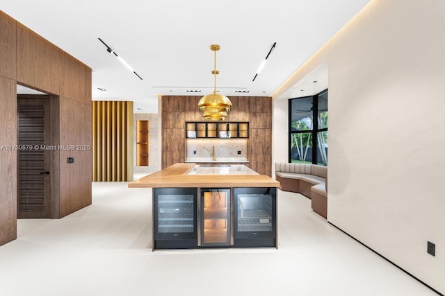 kitchen with modern cabinets, brown cabinets, and decorative light fixtures