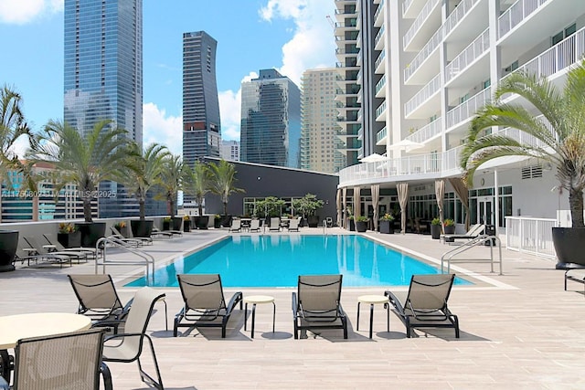 pool featuring a view of city and a patio