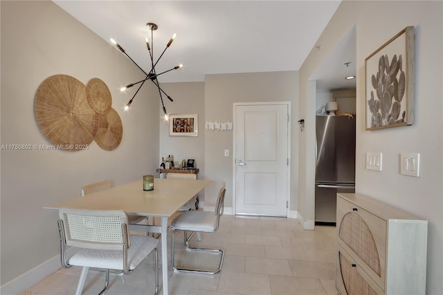 dining room with light tile patterned floors, an inviting chandelier, and baseboards