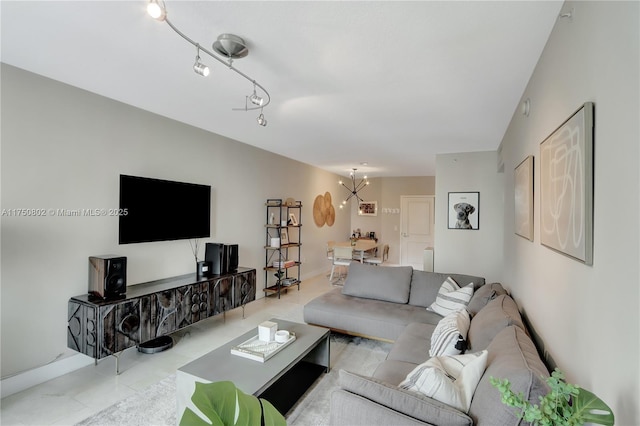 living room with track lighting and an inviting chandelier