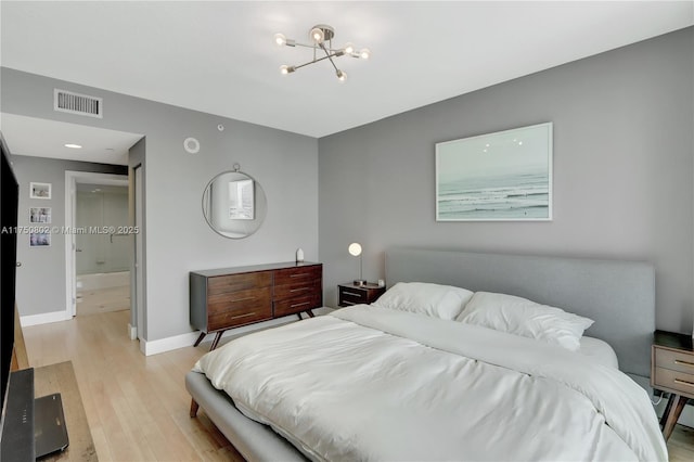 bedroom with light wood-type flooring, baseboards, visible vents, and a chandelier