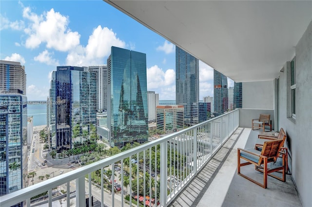 balcony with a water view and a city view