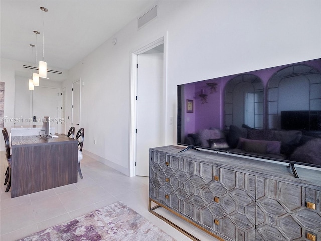 kitchen with light tile patterned floors, modern cabinets, visible vents, and baseboards