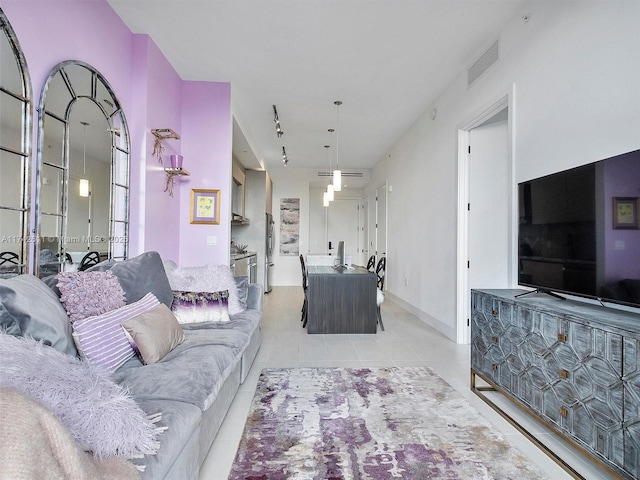 living room featuring light tile patterned floors and visible vents