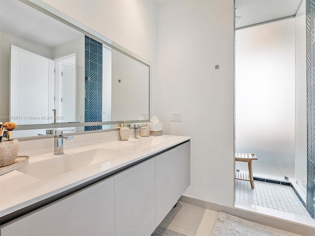 bathroom with tile patterned flooring, baseboards, and vanity