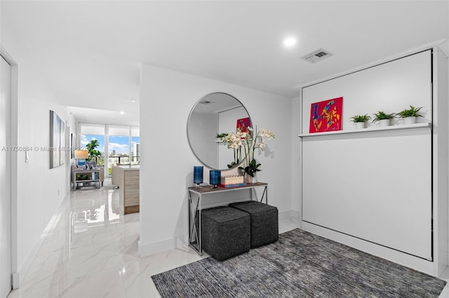 hall with marble finish floor, recessed lighting, visible vents, and baseboards