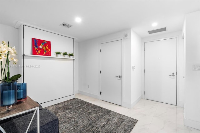 foyer featuring marble finish floor, visible vents, and recessed lighting