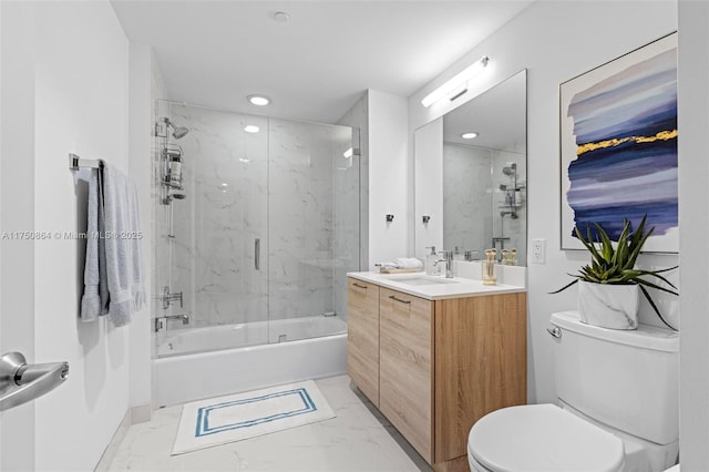 bathroom with marble finish floor, enclosed tub / shower combo, vanity, and toilet